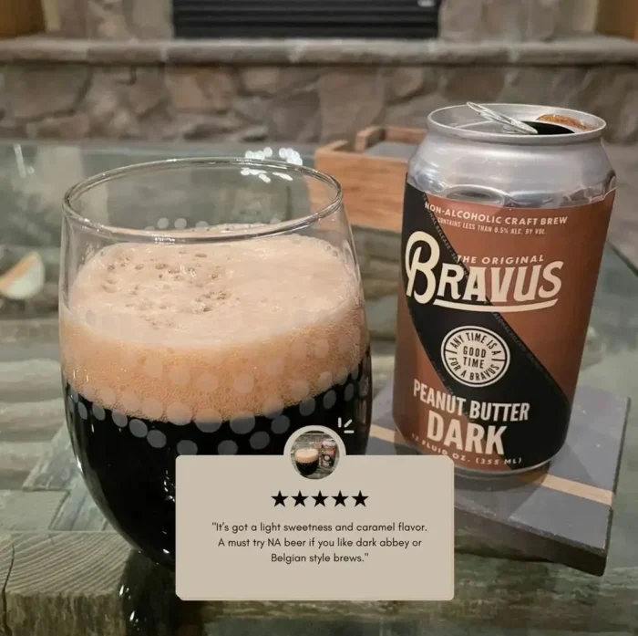 Bravus Peanut Butter Dark non-alcoholic beer can with a glass of dark beer featuring a creamy head and a 5-star customer review for a delicious flavor.