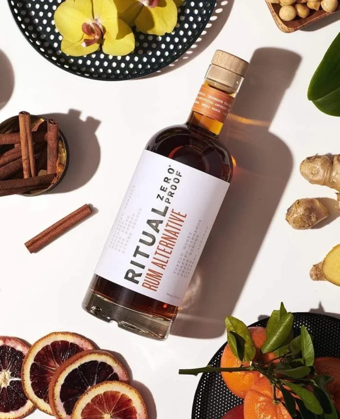 Ritual Zero Proof Rum Alternative surrounded by fresh ingredients for creative, alcohol-free cocktails.