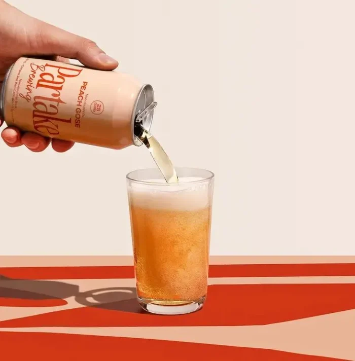 Trapl beer being poured into a glass, showcasing golden color and frothy foam on a stylish backdrop.
