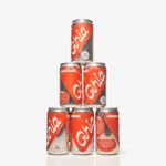 Ghia Ginger cans stacked in a pyramid formation with bold red and white branding on a white background.