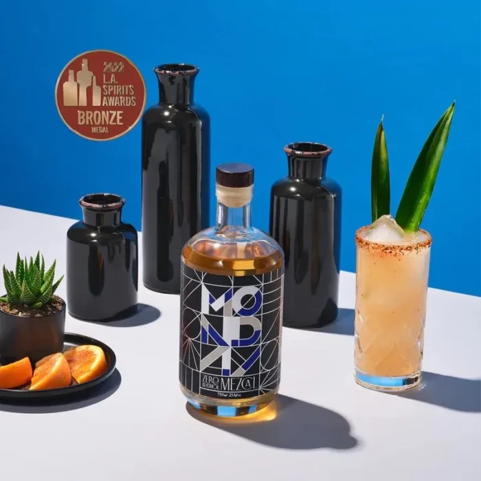 Monday tequila with vibrant cocktail and artistic black decor.