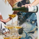 Pouring Surely sparkling wine into a champagne tower, showcasing elegance and celebration.