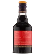 Rear view of a dark liquor bottle with a red label showing product details.