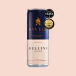 Savile Bellini non-alcoholic cocktail can with a navy and peach design, award labels on a peach background.