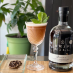 Seir Hill non-alcoholic beverage elegantly paired with a creamy cocktail garnished with fresh mint leaves.