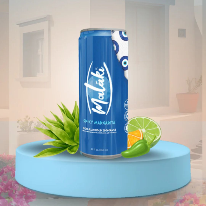 Blue energy drink can with eye design, lime, aloe vera, and chili garnish on a modern pedestal.