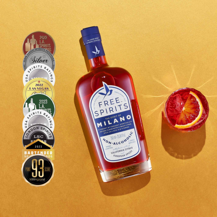 Free Spirits Milano non-alcoholic spirit bottle with a blood orange garnish and award medals on a golden background.