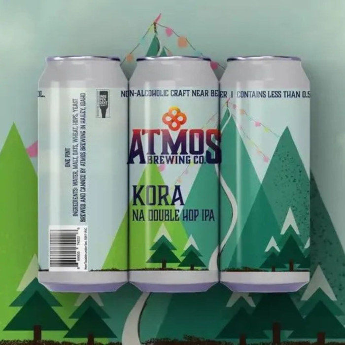 Atmos Brewing Co. Kora NA Double Hop IPA cans featuring a vibrant green mountain design, highlighting non-alcoholic craft beer with less than 0.5% ABV.