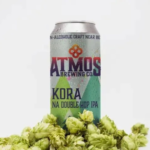 Atmos Brewing Co. Kora NA Double Hop IPA can surrounded by fresh hops, highlighting its bold flavor and non-alcoholic craft beer excellence.