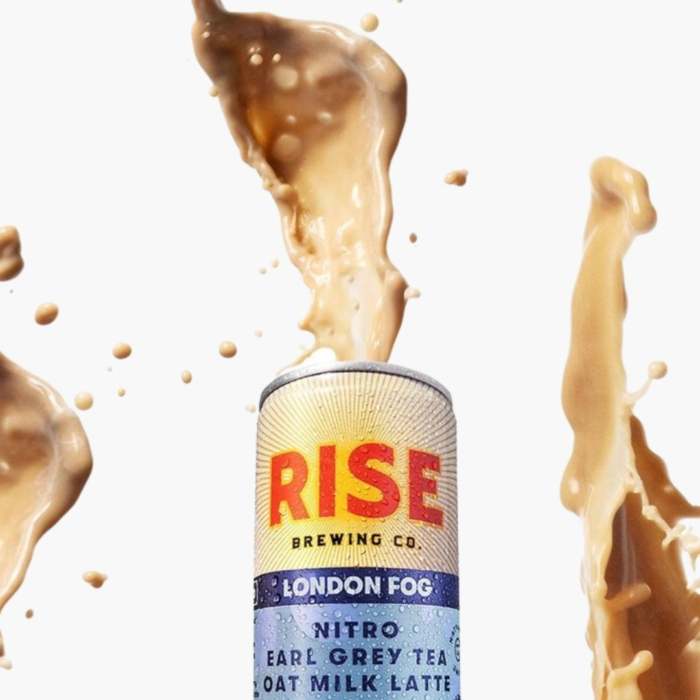 Rise Nitro London Fog Earl Grey Tea Oat Milk Latte can with creamy splashes against a white background.
