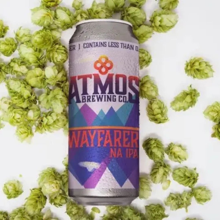 Atmos Brewing Co. Wayfarer NA IPA: A vibrant and adventurous design surrounded by fresh hops, emphasizing its bold and refreshing IPA character with non-alcoholic craftsmanship.