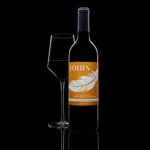 Elegant bottle of non-alcoholic wine with a glass, beautifully reflected on a black background.