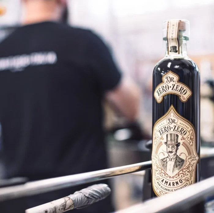 The Blind Tiger non-alcoholic spirit bottle with vintage-style label displayed in an industrial setting.