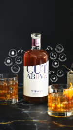 Bottle of Cut Above Whiskey on a black background surrounded by illustrations highlighting its key features, such as low calorie, gluten-free, and non-alcoholic, with glasses of whiskey in the foreground.